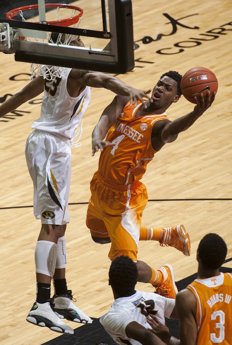 Tennessee's Armani Moore, right, shoots past Missouri's Jakeenan Gant, left, during their game Saturday, Jan. 17, 2015, in Columbia, Mo.