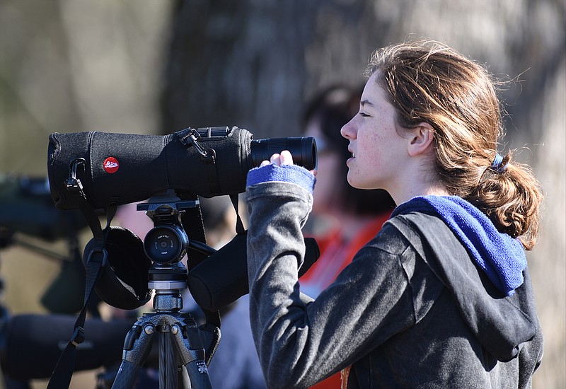 Fiona Broadie adjusts a scope before taking a close-up look at a Sandhill Crane Sunday during the Tennessee Sandhill Crane Festival at the Hiwassee Wildlife Refuge. 