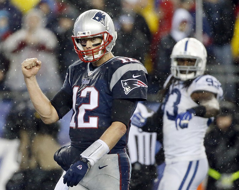 New England Patriots quarterback Tom Brady (12) celebrates LeGarrette Blount's touchdown during the second half of the NFL football AFC Championship game against the Indianapolis Colts Sunday, Jan. 18, 2015, in Foxborough, Mass. 