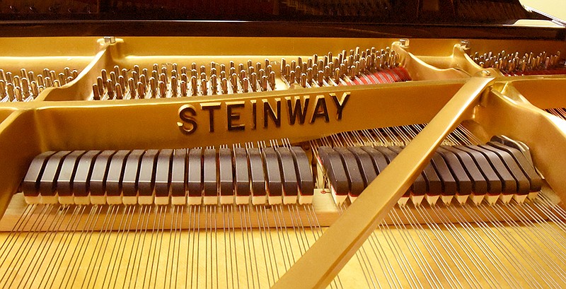 A detail view of the inside of a Steinway grand piano.