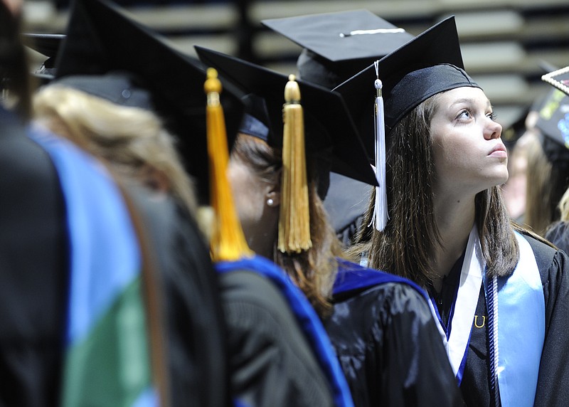 Students from the University of Tennessee at Chattanooga march down the blue carpet towards their seats at the UTC graduation ceremony held on Saturday, May 5, 2012, at McKenzie Arena.