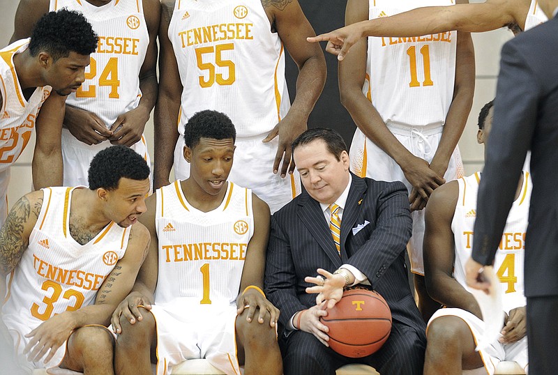 Tennessee's head basketball coach Donnie Tyndall shows his Conference USA championship ring to UT players, from left, Jabari McGhee, Brandon Lopez and Josh Richardson as the group prepares for a team portrait during the teams media day at the University of Tennessee's Pratt Pavillion in Knoxville on Thursday, Oct. 16, 2014.