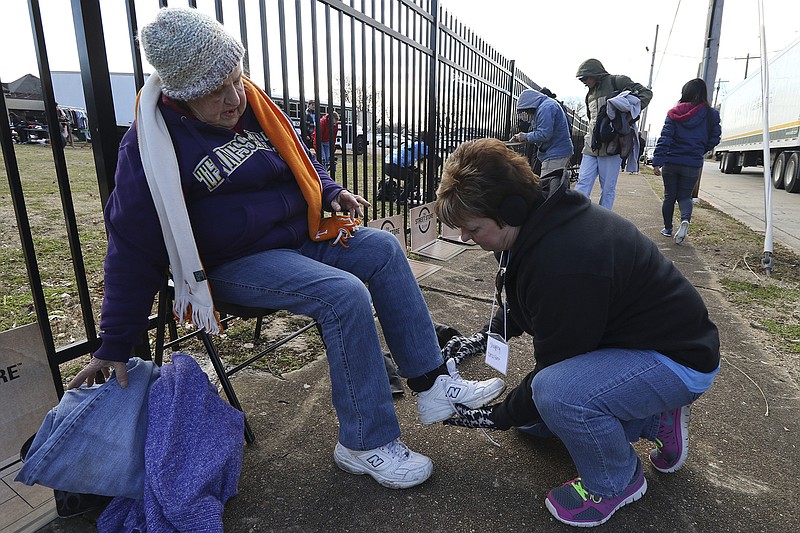 Wanda Rodewald, left, is aided by Tricia Foster in picking out a new pair of shoes during the "Street Store" event run by Southern Adventist University and Salvation Army volunteers offering free clothes and lunches for the homeless as a Martin Luther King Day service project on Monday.