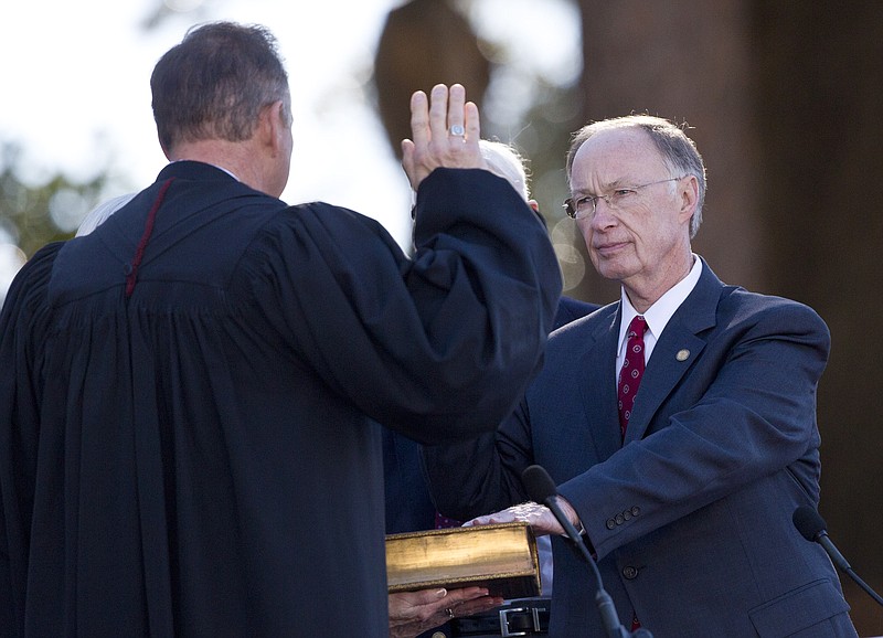 Gov. Robert Bentley takes the oath of office for his second term from Alabama Chief Justice Roy Moore on Monday, Jan. 19, 2015, at the state Capitol in Montgomery, Ala. 