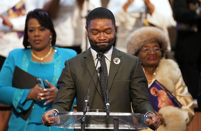 Actor David Oyelowo, who portrays the Rev. Martin Luther King Jr. in the movie "Selma," prepares to speak during a service honoring King at Ebenezer Baptist Church, where King preached, Monday, Jan. 19, 2015, in Atlanta. Also pictured are King's daughter Bernice King, left, and his sister Christine King Farris, right.