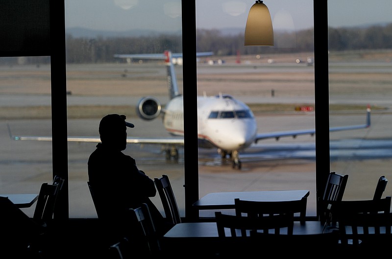  Luke Sparks watches planes at the Chattanooga Airport while waiting for his girlfriend to arrive. The Chattanooga Airport set a passenger record in 2014. 