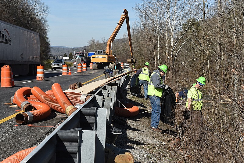 Workers from Marion Environmental Inc. finish cleanup efforts Tuesday near Haletown, Tenn., in the aftermath of a truck wreck on Thursday.