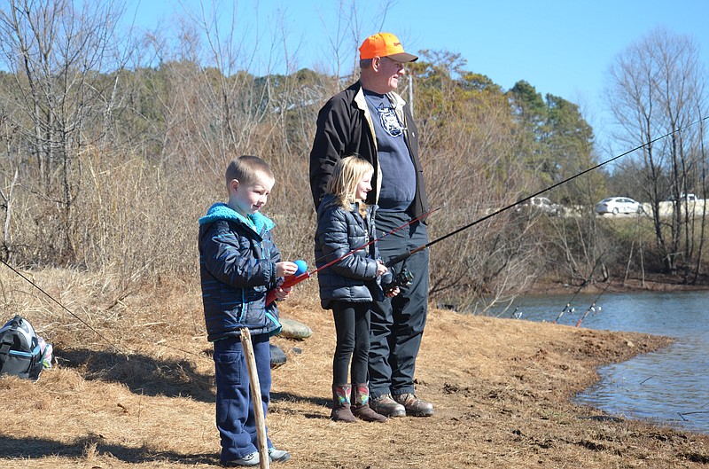 Luther Kocher of Chattanooga watches as his grandchildren, Corinne and Xander Stuarte, fish for rainbow trout from the shore at Lake Junior last weekend. Fishing is allowed there Fridays through Sundays through April.
Photo by Gary Petty