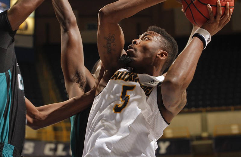 The University of Tennessee at Chattanooga's Justin Tuoyo (5) drives to the basket while playing against Coastal Carolina in this Nov. 27, 2014, photo. 