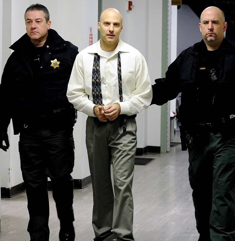 Hugo Selenski, center, is led into the Luzerne County Courthouse, in Wilkes-Barre, Pa., Monday, Jan. 12, 2015, for day three of jury selection in his double homicide trial. 