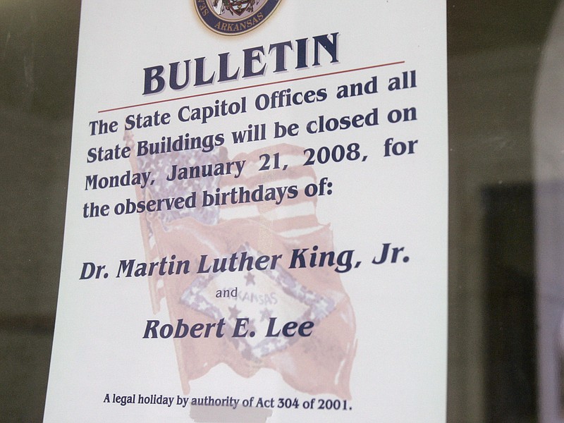 In this 2008, file photo, a note is posted on a door at the Arkansas state Capitol in Little Rock, Ark., indicating state offices will close in observance of civil rights leader Martin Luther King Jr. and Confederate General Robert E. Lee's birthdays. 