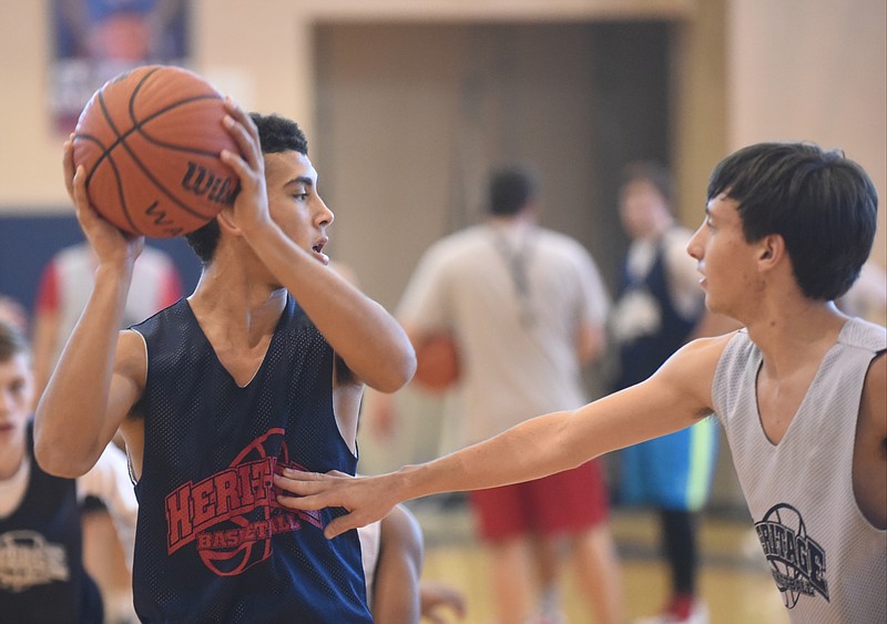 Heritage High School's Jaylon Gaines, left, and Hunter Erickson guard each other during drills at the school.