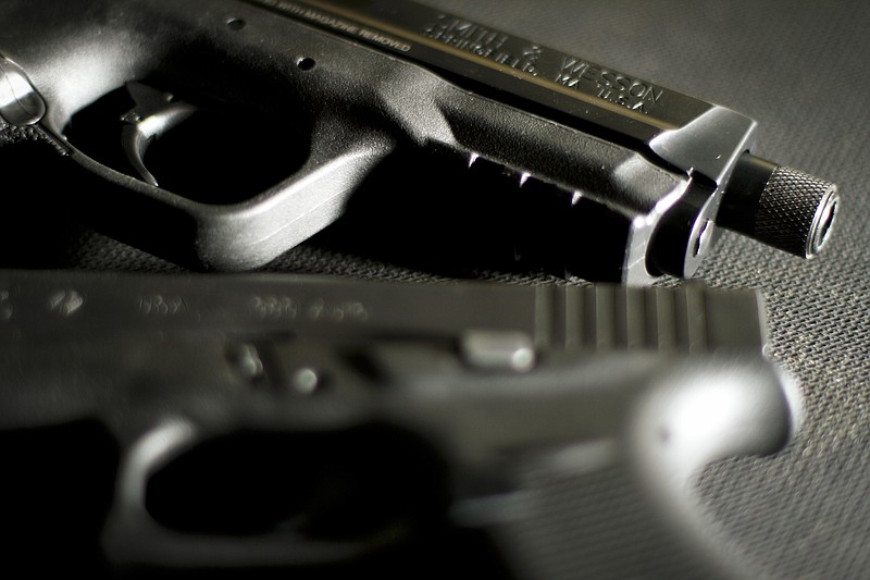 A Smith and Wesson M&P 9 and Glock42 380 semi-automatic handgun rest on a plastic mat inside of Shooters Depot on August 14, 2014.