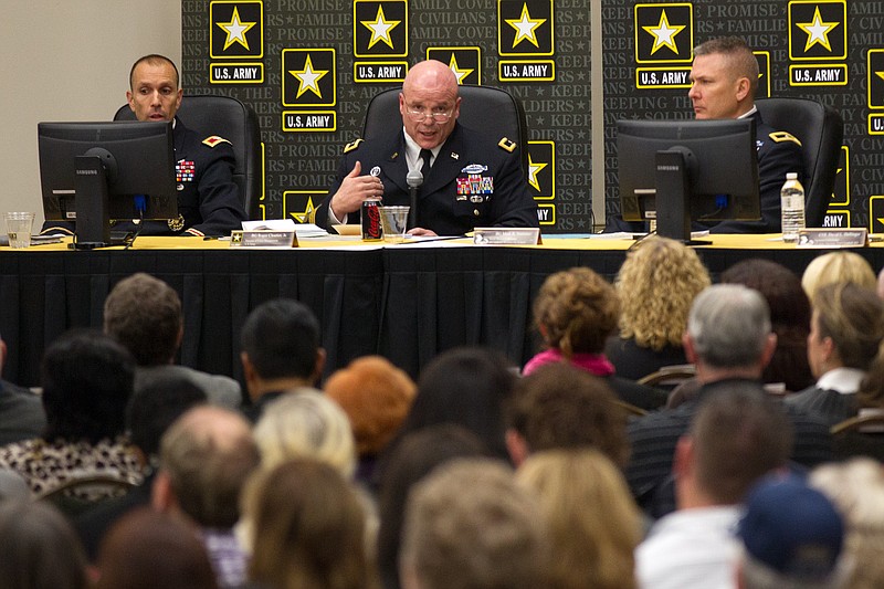 Army Brig. Gen. Roger Cloutier Jr., center, addresses an overflow crowd at a "listening session" about potential cuts at Fort Campbell, Ky., on Tuesday, Jan 20, 2015. Under the Army's worst-case scenario, the sprawling post on the Kentucky-Tennessee line could lose up to 16,000 soldiers and civilians by 2020. (AP Photo/Erik Schelzig)