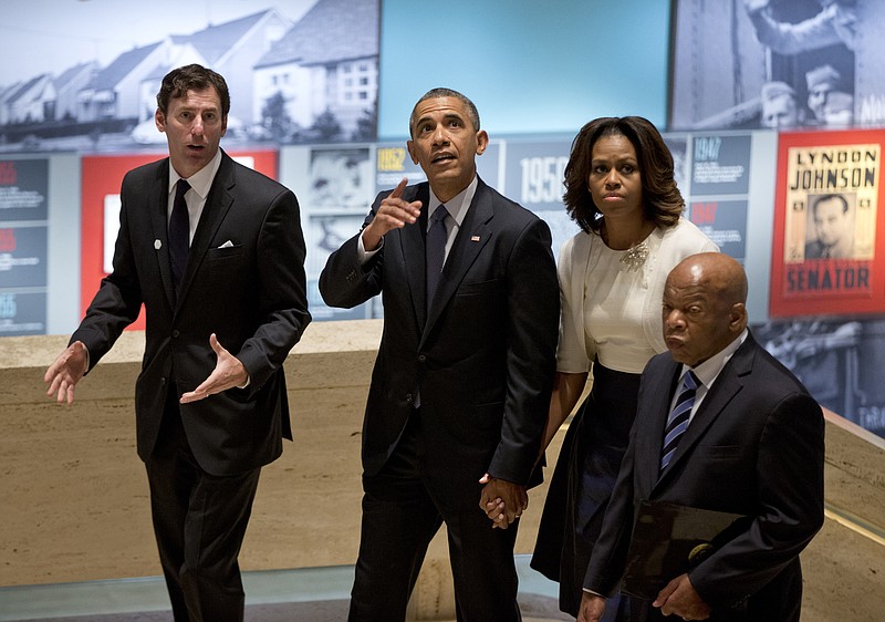 In this April 10, 2014, file photo, from left, LBJ Presidential Library Director Mark Updegrove, President Barack Obama, first lady Michelle Obama and Rep. John Lewis, D-Ga., arrive in the Great Hall at the LBJ Presidential Library in Austin, Texas, to attend a Civil Rights Summit to commemorate the 50th anniversary of the signing of the Civil Rights Act.
