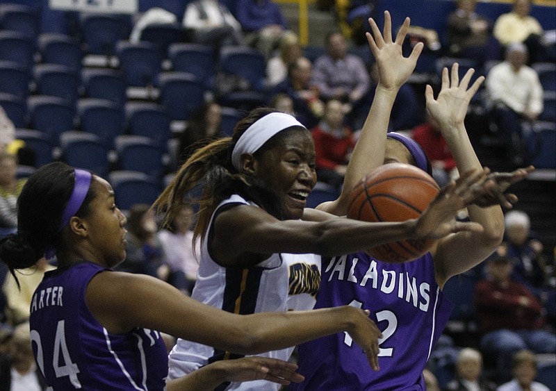 UTC's Jasmine Joyner, center, fights for a rebound with Furman's Cierra Carter, left, and Shianne Goodwin during the Mocs' SoCon basketball game against the Furman Paladins on Saturday, Jan. 24, 2015, at McKenzie Arena in Chattanooga, Tenn. UTC won 67-45.