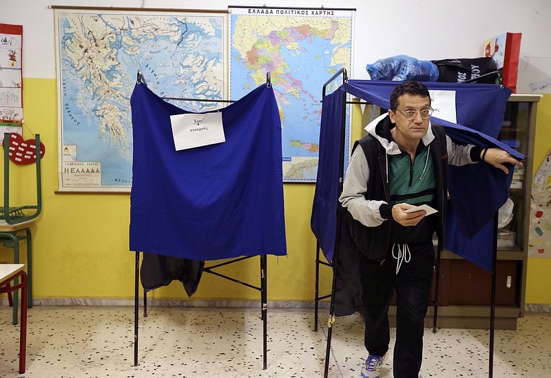 
              A man casts his vote at a polling station in Athens Sunday, Jan. 25, 2015. Greeks were voting Sunday in an early general election crucial for the country's financial future, with the radical left Syriza party of Alexis Tsipras tipped as the favorite to win, although possibly without a large enough majority to form a government. (AP Photo/Thanassis Stavrakis)
            