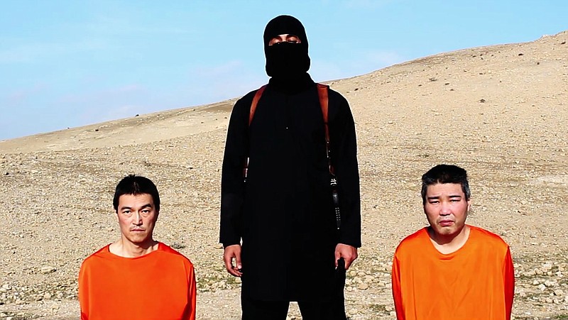 This file image taken from an online video released by the Islamic State group's al-Furqan media arm on Tuesday, Jan. 20, 2015, purports to show the group threatening to kill two Japanese hostages that the militants identify as Kenji Goto Jogo, left, and Haruna Yukawa, right, unless a $200 million ransom is paid within 72 hours.
            