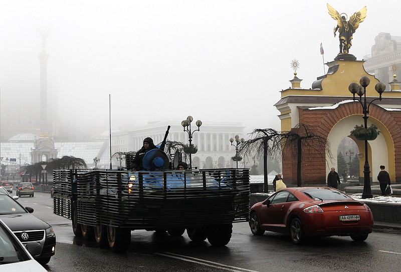 A Ukrainian military vehicle goes down the street on Independence Square in Kiev, Ukraine, Friday, Jan. 23, 2015. 