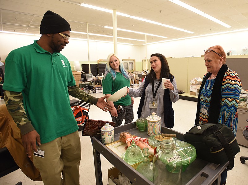 Randall Leslie, Amanda Willis, Sarah Hindmon and Kimberly Nelson, from left, sort items to research and list in the e-business division of Chattanooga Goodwill Industries. 