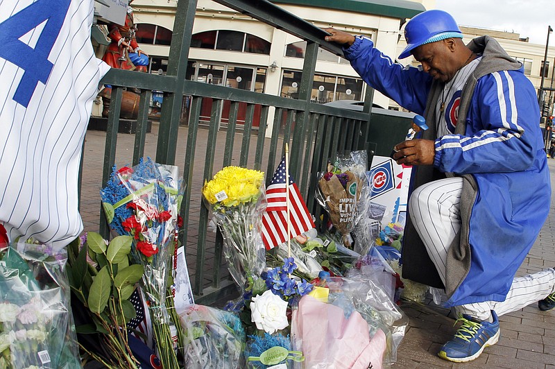 
              Ronnie Wickers (WooWoo) lays a doll outside Wrigley Field in remembrance of Cubs baseball legend Ernie Banks in Chicago, Saturday, Jan. 24, 2014. Banks died at the age of 83, Friday night at Northwestern Memorial Hospital in Chicago. (AP Photo/Nam Y. Huh)
            