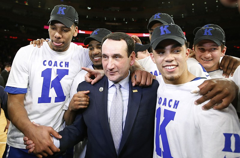 Duke head coach Mike Krzyzewski celebrates with his players after his 1,000th career win in an NCAA college basketball game against St. John's at Madison Square Garden in New York on Sunday, Jan. 25, 2015. 