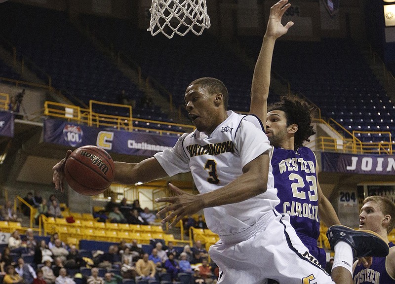 UTC's Lance Stokes (3) rebounds the ball ahead of Western Carolina's Justin Browning during the Mocs' SoCon basketball game against the Catamounts on Thursday, Jan. 8, 2015, at McKenzie Arena in Chattanooga.