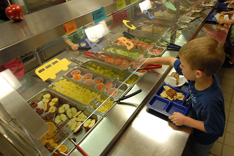 A student at Chattanooga Valley Elementary fills his plate in the school lunchline. 