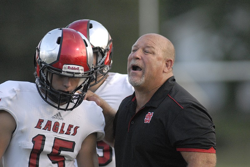 Eagle head coach Bill Price gives the play to John Ryan Wilson (15) at a game earlier this year at Tyner.
