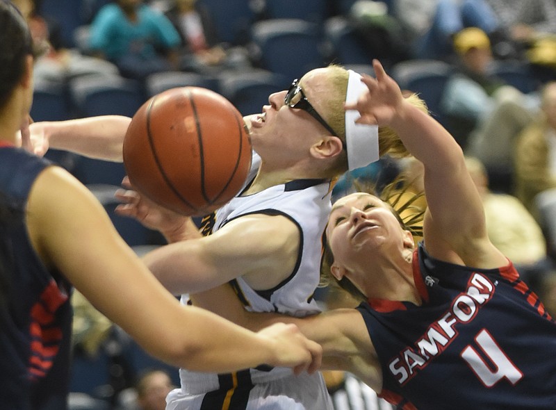 UTC's Alicia Payne and Samford's Lydia McGee grab for the ball Monday at McKenzie Arena. UTC won 49-32.