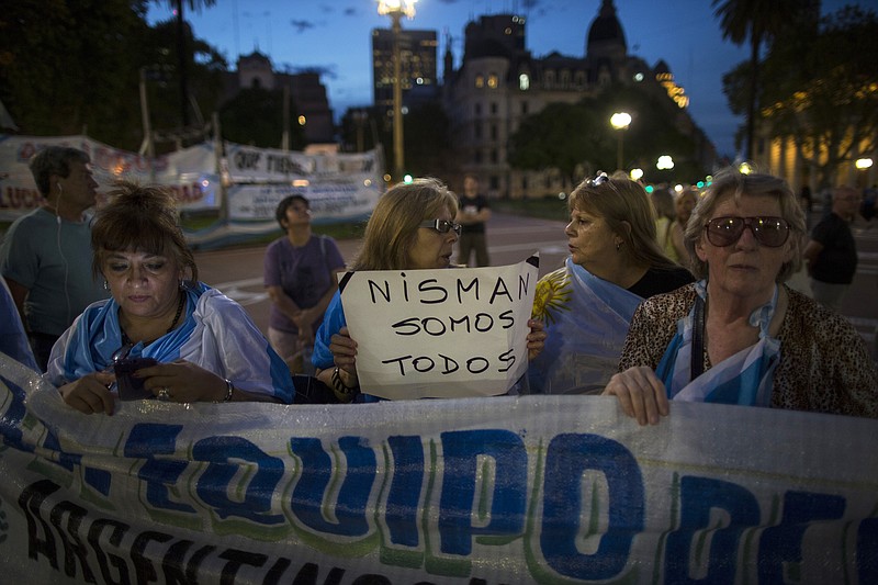 
              A protester carries a sign that reads in Spanish "We're all Nisman," referring to the death of special prosecutor Alberto Nisman, in Plaza de Mayo square in Buenos Aires, Argentina, Monday, Jan. 26, 2015. Nisman was found dead Jan. 18 in his apartment, the day before he was scheduled to elaborate on explosive allegations that President Cristina Fernandez shielded Iranian officials suspected in the largest terrorist attack in the South American country's history. (AP Photo/Ivan Fernandez)
            