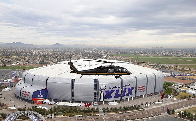 
              A U.S. Customs and Border Protection Black Hawk helicopter flies above University of Phoenix Stadium, site of the NFL Super Bowl XLIX football game, for a security demonstration for the media Monday, Jan. 26, 2015, in Glendale, Ariz. The Black Hawk helicopters and truck-sized X-ray machines have been brought to the Super Bowl venue to assist with the security effort. (AP Photo/Ross D. Franklin)
            