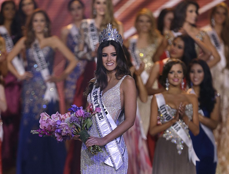 Miss Colombia Paulina Vega carries flowers after becoming Miss Universe at the Miss Universe pageant in Miami, Sunday, Jan. 25, 2015. 