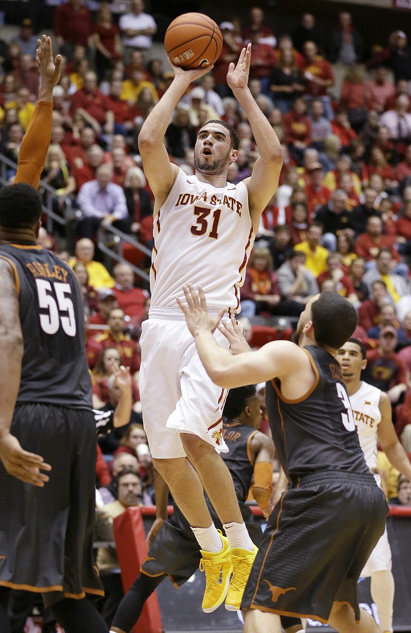 
              Iowa State forward Georges Niang (31) shoots over Texas guard Javan Felix, right, during the first half of an NCAA college basketball game, Monday, Jan. 26, 2015, in Ames, Iowa. (AP Photo/Charlie Neibergall)
            