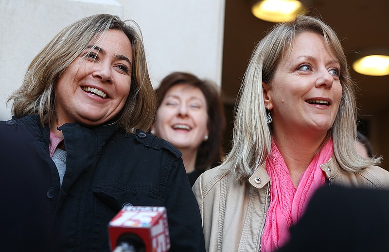 Cari Searcy, left, and her wife Kim McKeand, plaintiffs in the case that struck down Alabama's same-sex marriage ban on Friday, hold a press conference with their lawyers in front of the Mobile County Marriage License Office at Probate Court in Mobile, Ala., on Monday Jan. 26, 2015. Alabama on Monday began the process of appealing a federal judge's decision that overturned the state's ban on same-sex marriage, a decision that was put on hold to allow time for the appeal. 