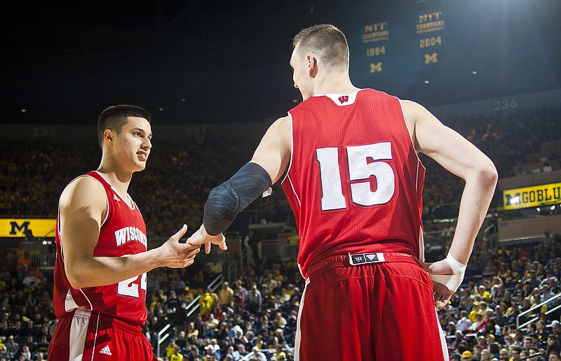 Wisconsin guard Bronson Koenig, left, and forward Sam Dekker (15) shake hands at the beginning of the second half of an NCAA college basketball game at Crisler Center in Ann Arbor, Mich., Saturday, Jan. 24, 2015. Wisconsin won 69-64 in overtime.