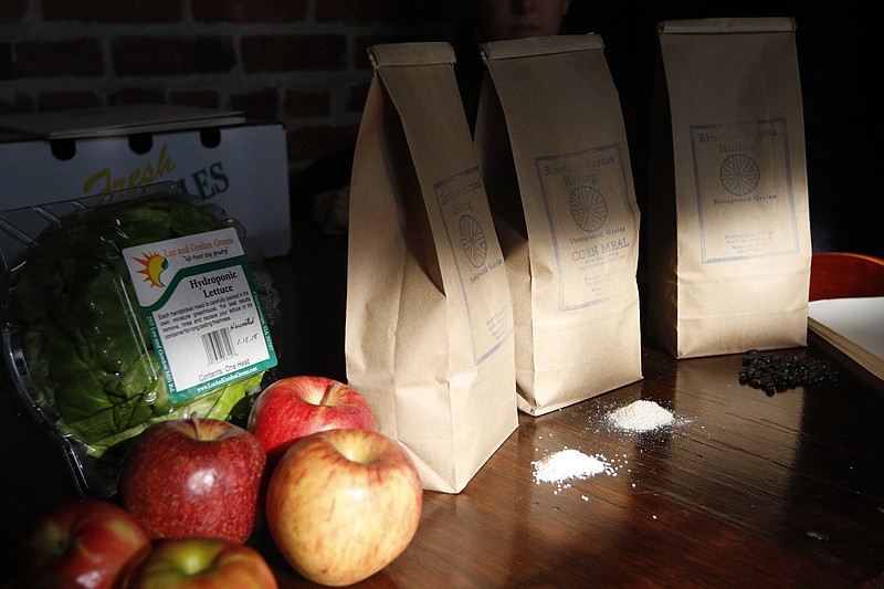 Goods from Harvested Here Food Hub are displayed on a table.