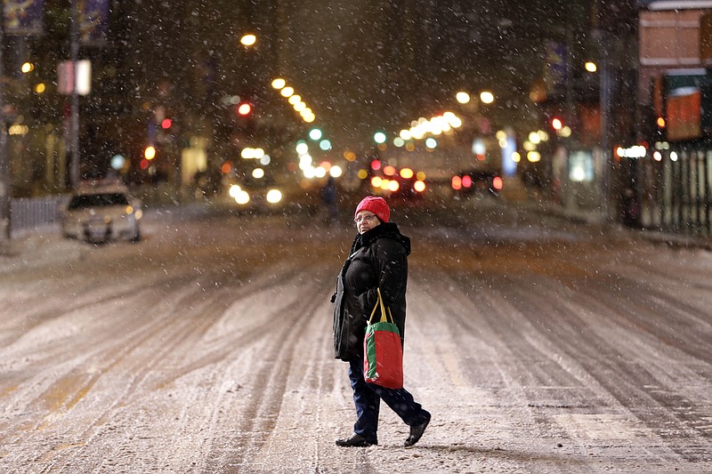 A woman crosses a mostly empty 42nd Street in Times Square, New York, Monday, Jan. 26, 2015. 