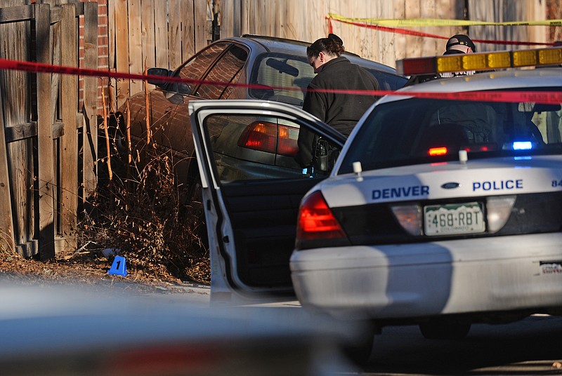 
              Denver police shot and killed a female suspect early Monday, Jan. 26, 2015, after they said she drove a stolen car at officers, hitting one of them in the leg. Neighbors described the driver as a teenager. (AP Photo/The Denver Post, RJ Sangosti)
            