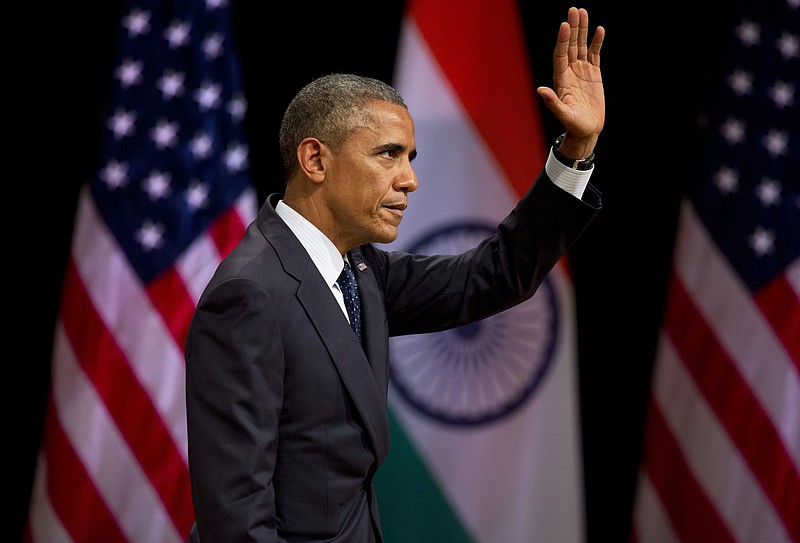 U.S. President Barack Obama waves to the audience after delivering a speech at the Siri Fort Auditorium, a government-run event center, in New Delhi, India, Tuesday, Jan. 27, 2015.