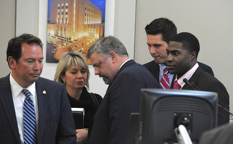 The defense gatherers after the jury was read the charges against Brandon Vandenburg and Cory Batey on Tuesday, Jan. 27, 2015 in Nashville, Tenn.  Vandenburg and Batey, two former Vanderbilt football players,  are each charged with five counts of aggravated rape and two counts of aggravated sexual battery.