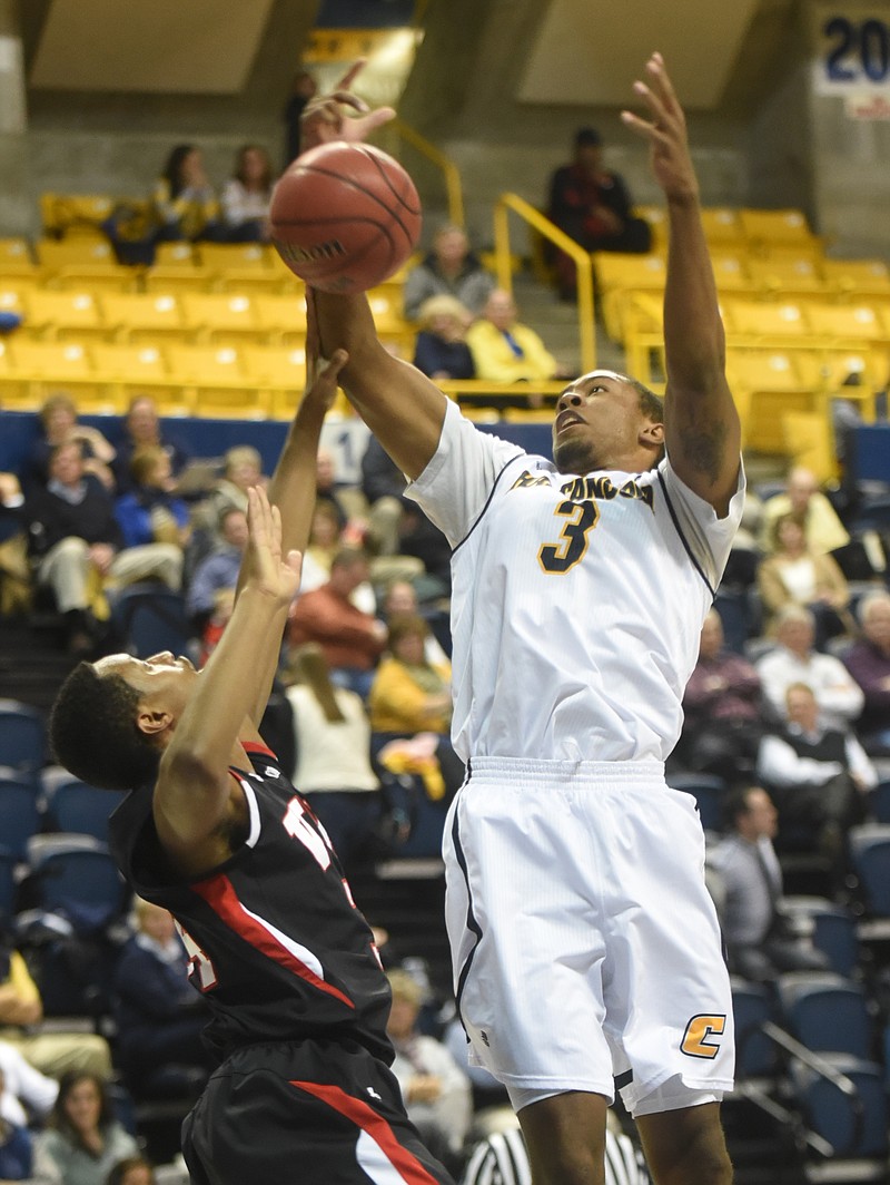 UTC's Lance Stokes snags a rebound as VMI's Jarid Watson guards at McKenzie Arena in this 2014 file photo.