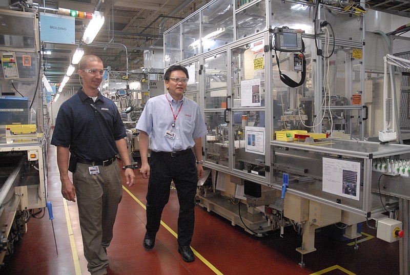 Staff walk through the Athens, Tenn., Denso Manufacturing plant in this file photo.