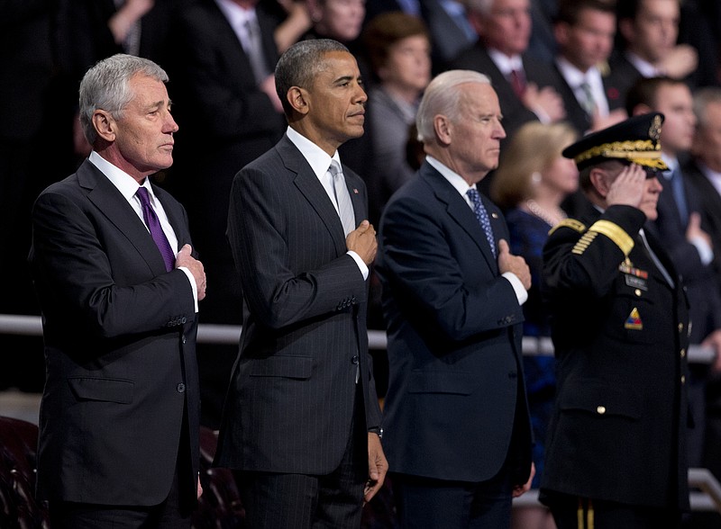
              From left, outgoing Defense Secretary Chuck Hagel, President Barack Obama,Vice President Joe Biden and Joint Chiefs Chairman  Gen. Martin Dempsey, put their hands over their heart as the National Anthem is played  during the farewell tribute in honor of Hagel, Wednesday, Jan. 28, 2015, at Fort Myer in Arlington, Va.   (AP Photo/Manuel Balce Ceneta)
            