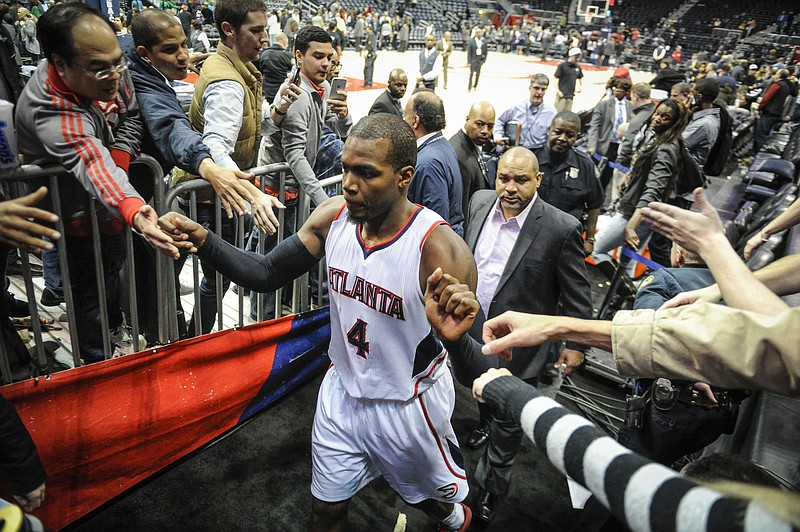 Atlanta Hawks forward Paul Millsap (4) leaves the court as fans reach out to him after his game against the Brooklyn Nets, Wednesday Jan. 28, 2015, in Atlanta. Atlanta won 113-102.
