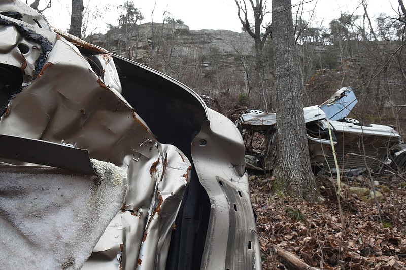 A vehicle where human remains were found is seen at left near other vehicles under a bluff near the Lookout Mountain hang gliding launch just south of Burkholder Gap Road on Thursday, Jan. 29, 2015, in Dade County, Ga. 