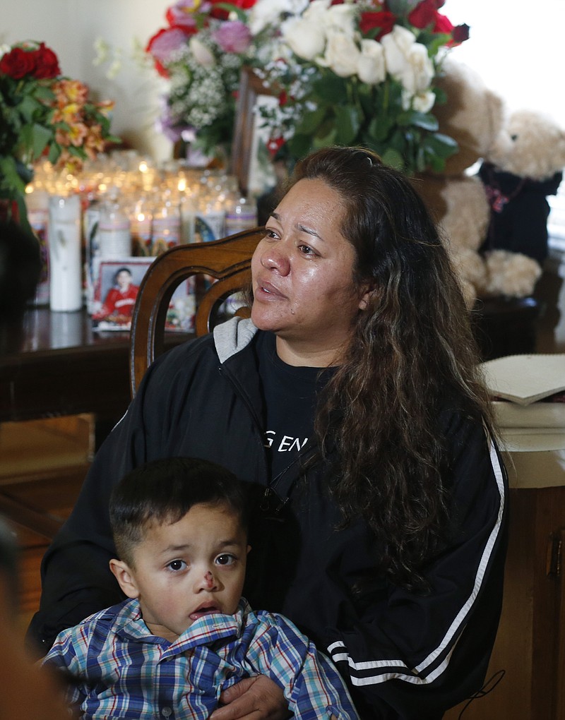 
              Laura Hernandez talks with reporters in her Thornton, Colo., home on Wednesday, Jan. 28, 2015, about the death of her 17-year-old daughter Jessica, who was killed after she allegedly hit and injured a Denver Police Department officer while driving a stolen vehicle early Monday in northeast Denver alleyway. Hernandez's 4-year-old son, Kevin, sits with his mother. (AP Photo/David Zalubowski)
            