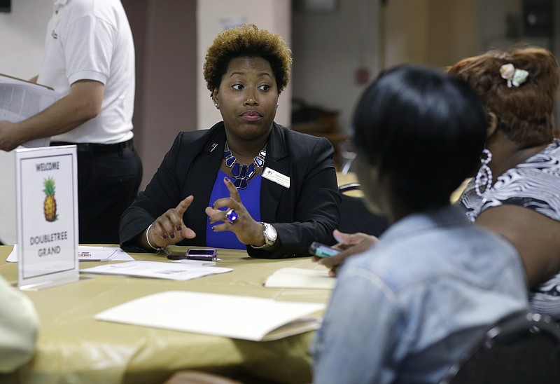 
              In this Friday, Jan. 23, 2015 photo, Natalie Parker, director of human resources at the Doubletree Grand, left, talks with job applicants during a job fair at the Hospitality Institute. On Thursday, Jan. 29, 2015, the U.S. Labor Department reports on the number of people who applied for unemployment benefits a week earlier. (AP Photo/Lynne Sladky)
            