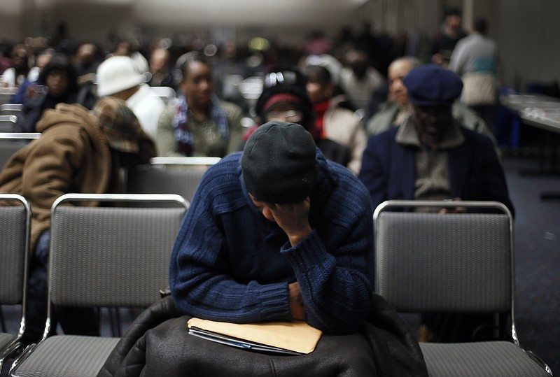 
              Homeowners sit in a conference room in Detroit's Cobo Center while waiting for their cases to be heard to avoid foreclosure from tax debts in Detroit Thursday, Jan. 29, 2015. Hundreds of Detroit homeowners at risk of losing their property are flocking to hearings that offer them a last-ditch chance to avoid foreclosure. (AP Photo/Paul Sancya)
            