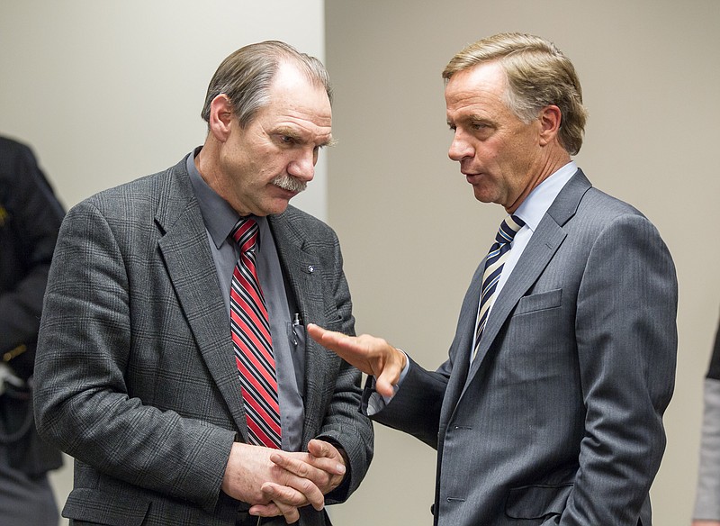 
              Gov. Bill Haslam confers with state Rep. Mark Pody, R-Lebanon, after a Thursday, Jan. 29, 2015, meeting with lawmakers in Murfreesboro, Tenn., to discuss his proposal to extend health coverage to more than 280,000 low-income Tennesseans. (AP Photo/Erik Schelzig)
            